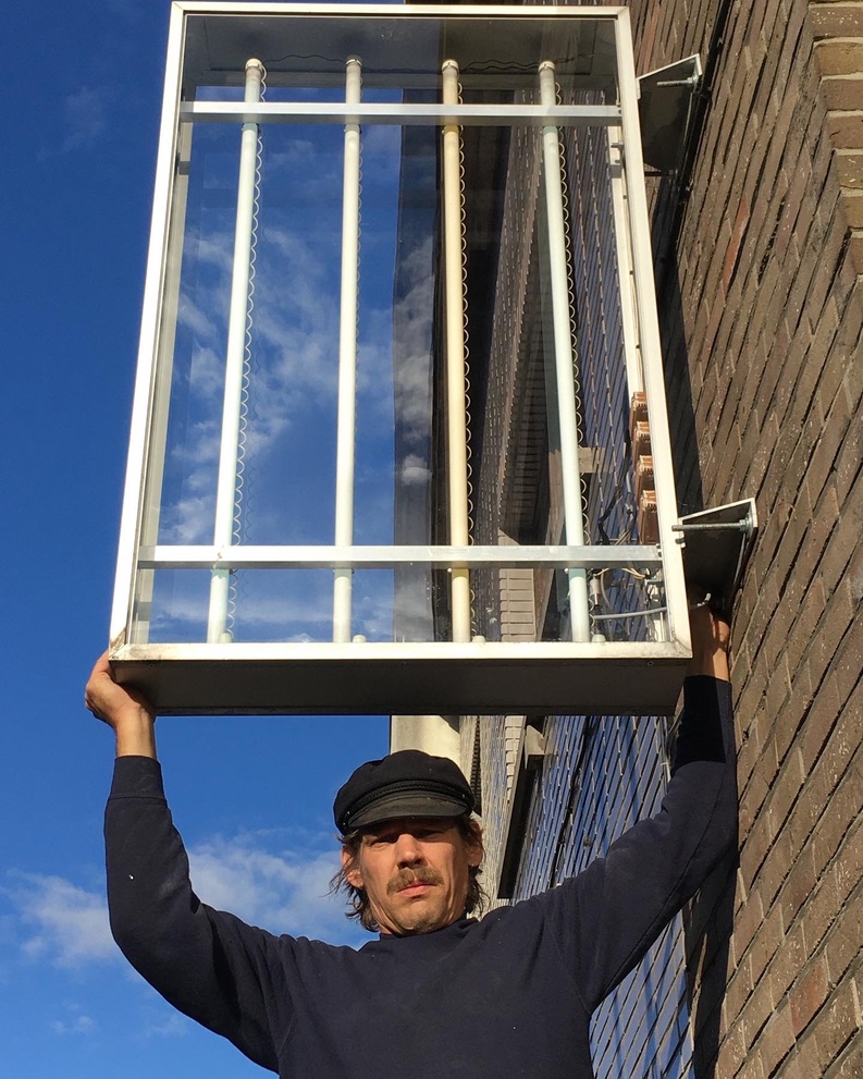 Bert Drieghe with the see-through light case he reconstructed for the exhibition and that will remain the gallery.